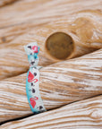 pink flamingo hair tie on a blue ocean background.