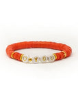red Heishi bracelet on a stretched cord