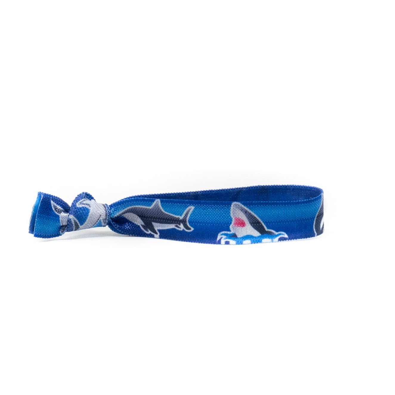 gray shark hair tie on a blue background. Perfect for little shark lovers!