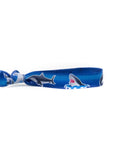 gray shark hair tie on a blue background. Perfect for little shark lovers!