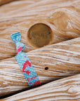 Dive into a magical underwater world with our adorable mermaid hair tie.