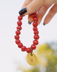 red handmade beaded bracelet with love charm